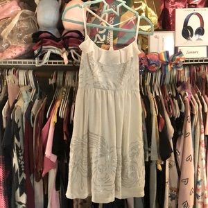 White dress. Side invisible zipper on side. Silver sequin design. Worn 1 time.